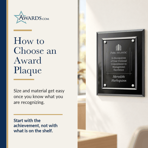 Black glass award plaque with a floating engraved panel on an office wall